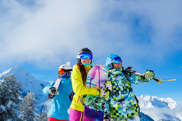Men and woman with snowboard and skis looking in different directions standing on snow resort...