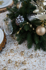 New year table decor. Christmas table with candles, plates and decorations.