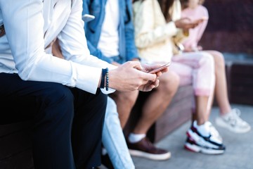 Obraz premium People sitting with smartphones, reading messages, posts in social networks.