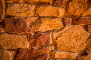 Stone texture. Brown and terracotta rock background. Surface of the rock. Close up of rock texture. Background for design. Copy space.