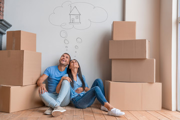 Young couple with dreaming about moving into new house