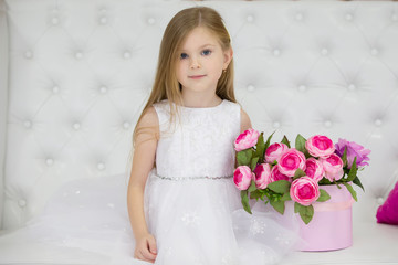 Beautiful child girl with flowers.