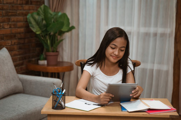 portrait of young teenager junior high school student studying at home