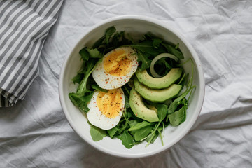 healthy green salad. Boiled eggs, herbs, onions and dressing. 