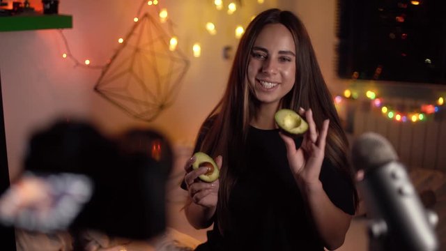 Vlogger influencer creating explainer video. Young beautiful blogger recording her video about healthy food