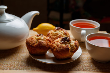 ready breakfast with muffins and lemon tea for two