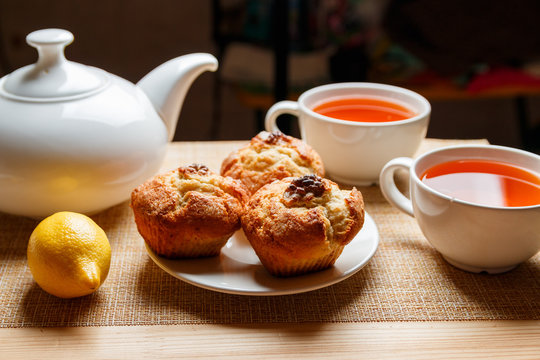 ready breakfast with muffins and lemon tea for two