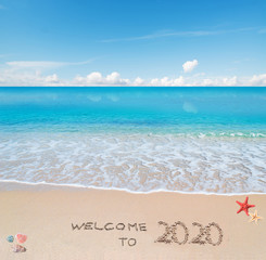 Fototapeta na wymiar welcome to 2020 written on the sand