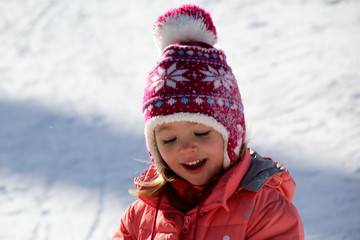 La petite fille joue dans la neige 
