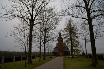 Fototapeta na wymiar old historic historical wooden church on a gray autumn november day,