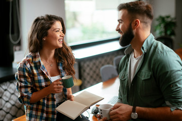 Colleagues in office. Businesswoman and businessman discussing work in office. Two friends in working together.