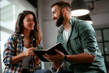 Colleagues in office. Businesswoman and businessman discussing work in office. Two friends in working together.