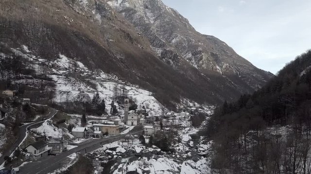 Cinematic aerial view at Lavertezzo, Switzerland in winter season. Lavertezzo is a small village with a valley and mountains along the river Verzasca in the Swiss canton Ticino.