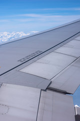 Views seeing from a window seat of an airplane. Looking down seeing islands, sea of clouds and ocean with a clear sunny sky during a summer time. Nice Journey from above the sky.