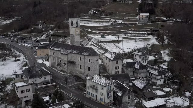 Cinematic aerial view at Lavertezzo, Switzerland in winter season. Lavertezzo is a small village with a valley and mountains along the river Verzasca in the Swiss canton Ticino.