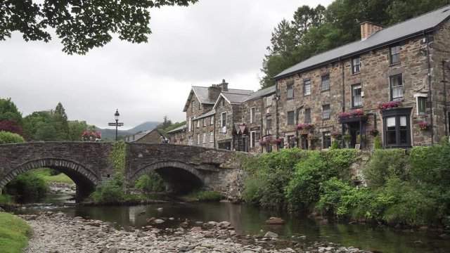 Stone bridge and old Welsh houses in Beddgelert, North Wales, UK