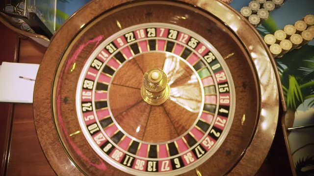 roulette spinning in casino, close up croupier hands, luxury entertainment ,ball spinning around