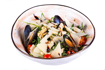 Salad with shells, vegetables and pieces of parmesan cheese