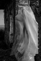 Slender nude girl, covered by a cellophane film, through which only her silhouette is visible and...