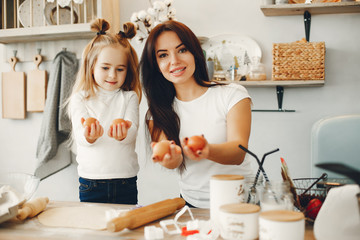 Family in a kitchen. Beautiful mother with little daughter