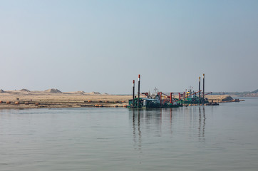 Extraction of building materials for the construction industry, beside the Irrawaddy river, Myanmar (Burma).