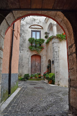 Obraz premium Fornelli, 11/23/2019. A narrow street among the old houses of a mountain village in the Molise region