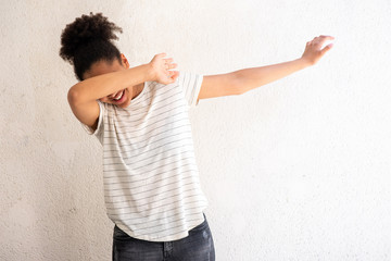 young african american girl dabbing by white background