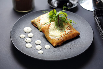 Pancakes with vegetable stuffing, appetizing dish. Stuffed pancakes