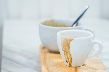 Dirty cup after drinking coffee . Empty used cup  . Hurry busy time . modern lifestyle in city .