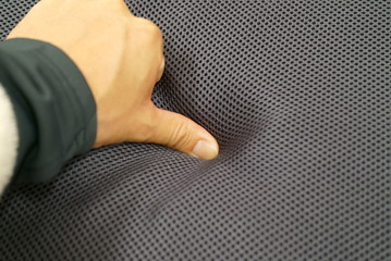 Hand to check the softness of the cushion