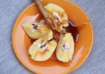 Very tasty breakfast made of baked quail fruit and buckwheat honey