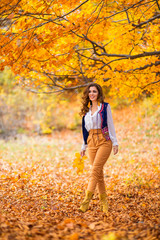 Portrait of a beautiful woman in autumn landscape