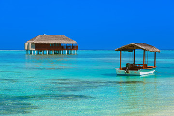 Boat and bungalow on Maldives island