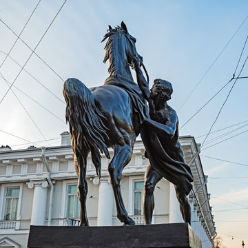 Anichkov Bridge in St. Petersburg with sculptures of horses and a sunny summer morning. Inscription on the bridge: Passage of ships is prohibited.