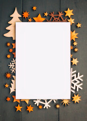 The beautiful christmas background wit hlots of small wooden decorations on the dark wooden desk.
