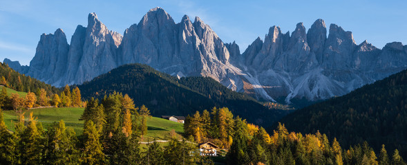 Autumn evening Santa Magdalena famous Italy Dolomites village surroundings in front of the Geisler or Odle Dolomites mountain rocks. Picturesque traveling and countryside beauty concept background. - obrazy, fototapety, plakaty