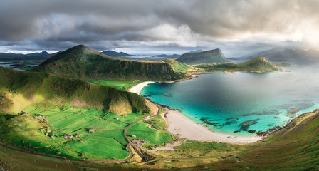 turquoise white sand beach and lush green grass during sunset Norway Loforen