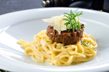 Spaghetti with tartare in a withe dish