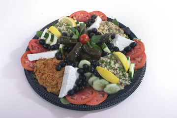 Greek food plate with grape leafs and cheese