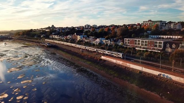 Train pulling onto railway station sunset Essex