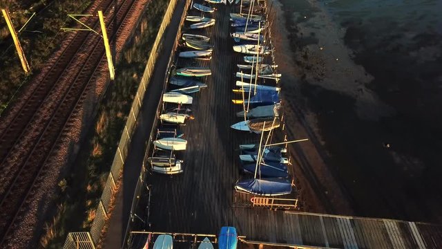 Over head aerial view from above over sail boats docked on pier