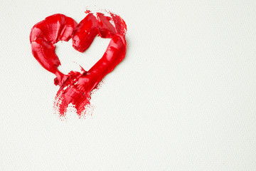 Red heart on white canvas