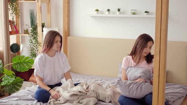 Friends quarrel. Anger offense betrayal. Two teen girls sorting out relationship at home.