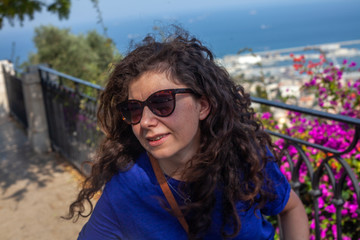 Woman posing in the shadow during bright sun