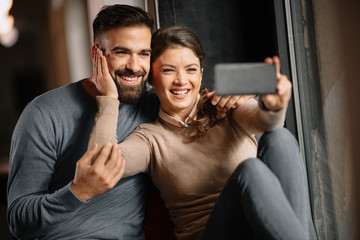 Happy couple taking selfie. Girlfriend and boyfriend together having fun. Happy couple.