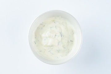 cream sauce with pickles in a bowl on a light background, mayonnaise