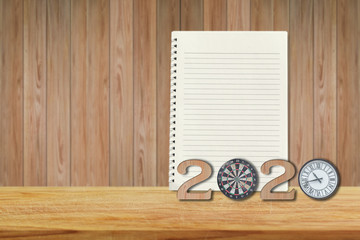 2020 Happy New years with notebook and wooden number on table. Goals and Mission Concept