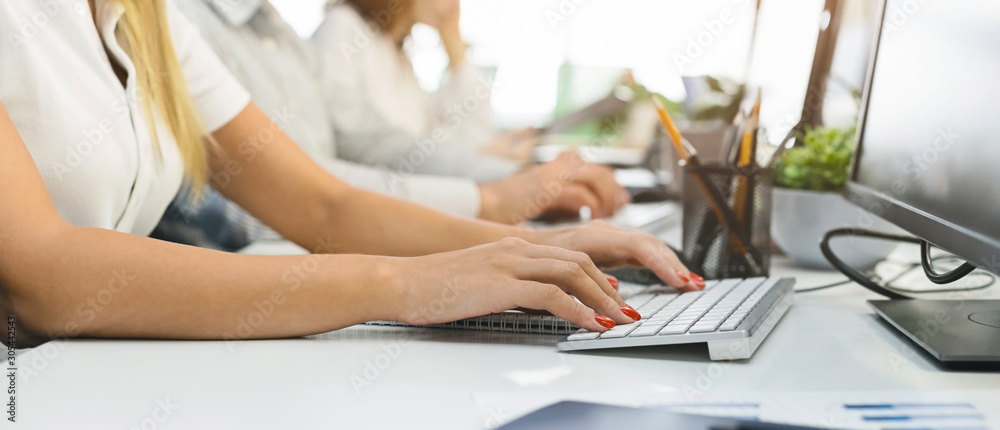 Poster female hands typing on computer keyboard at workplace