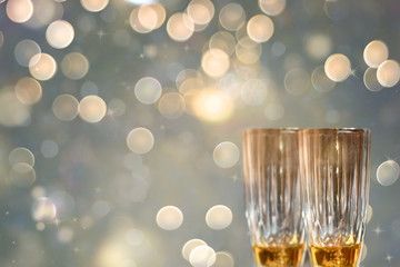 Glasses of champagne with bokeh lights background.