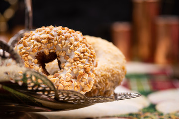 Doughnuts and doughnut holes on silver dessert stand